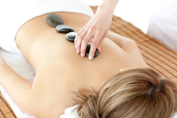 Bright woman having a stone therapy — Stock Photo, Image