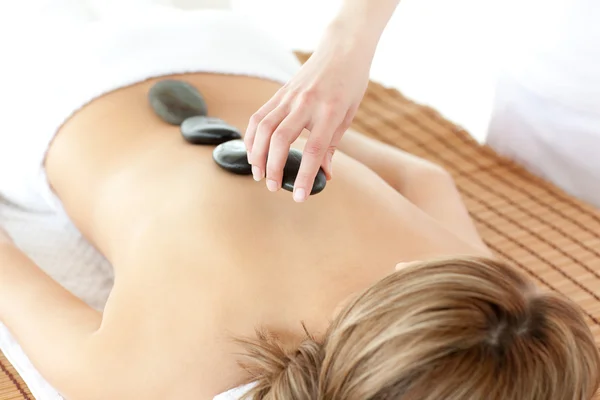 Radiant woman having a stone therapy — Stock Photo, Image