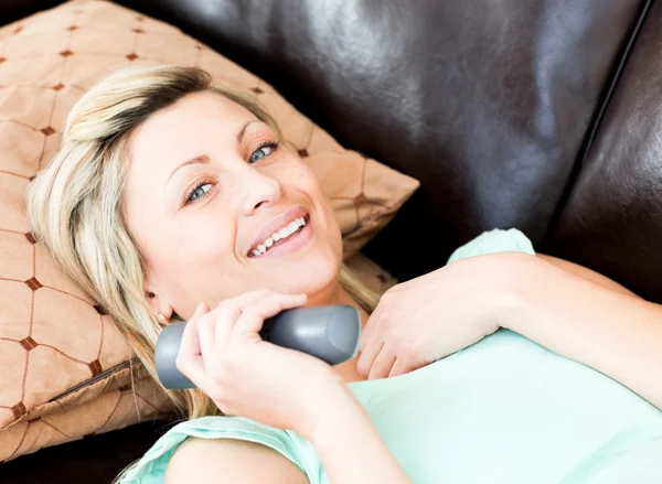 Happy woman using a remote — Stock Photo, Image