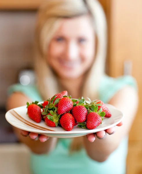 Positive woman showing fruits — Stock Photo, Image