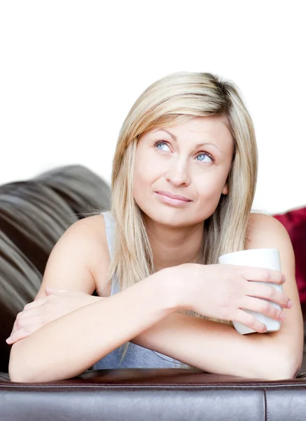 Pensive woman holding a cup of coffee — Stock Photo, Image