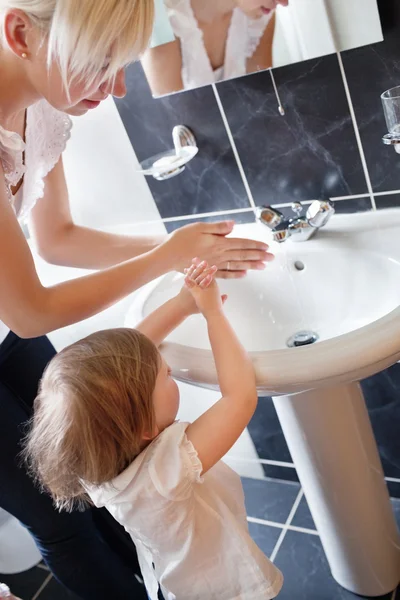 Mother and cute child washing their hands — Stock Photo, Image