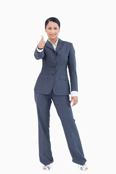 Standing businesswoman giving thumb up — Stock Photo, Image