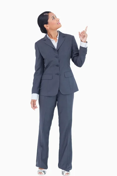 Businesswoman pointing and looking up — Stock Photo, Image