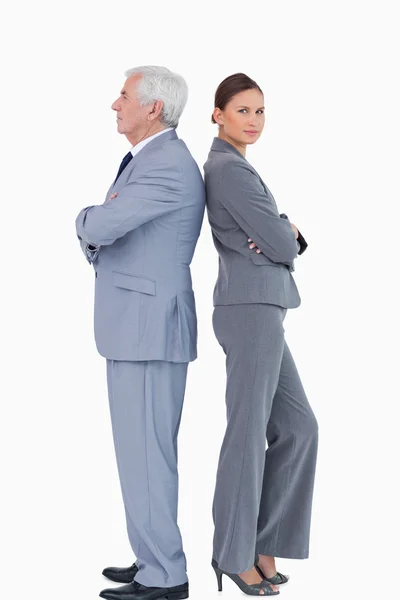 Mature businessman back to back with colleague — Stock Photo, Image