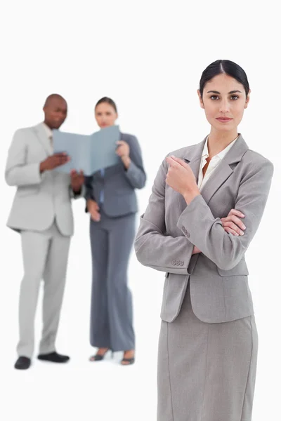 Serious saleswoman with colleagues behind her — Stock Photo, Image