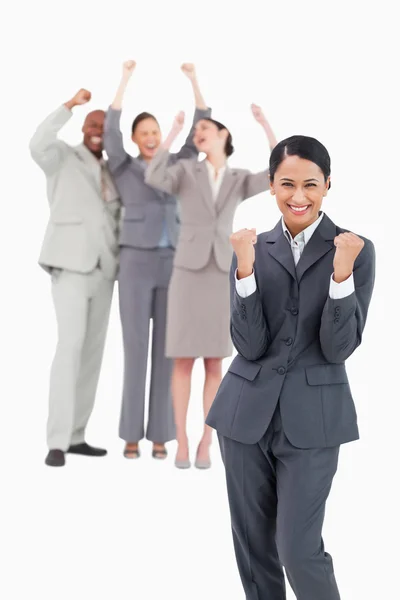 Successful saleswoman with cheering team behind her — Stock Photo, Image