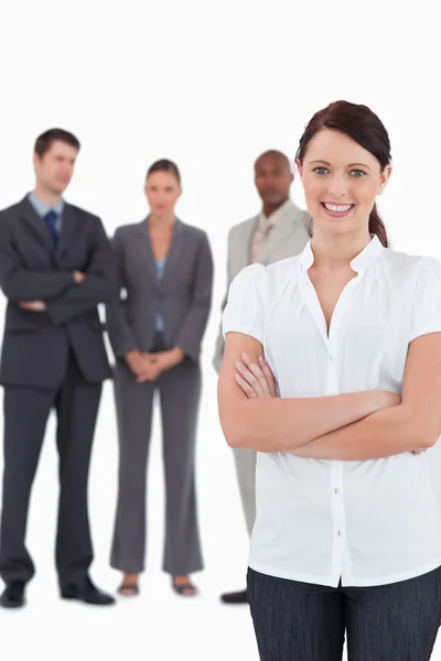 Businesswoman with arms folded and three colleagues behind her — Stock Photo, Image