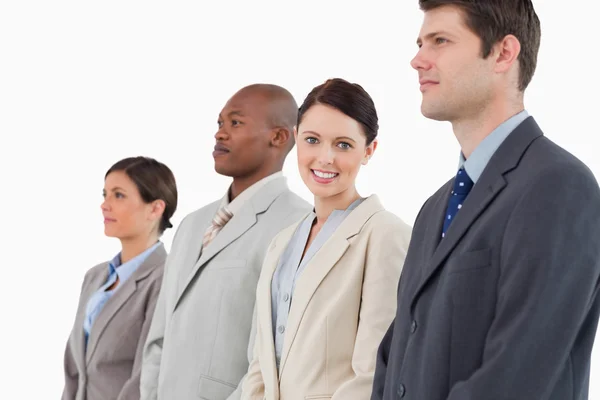 Smiling businesswoman standing between her colleagues — Stock Photo, Image