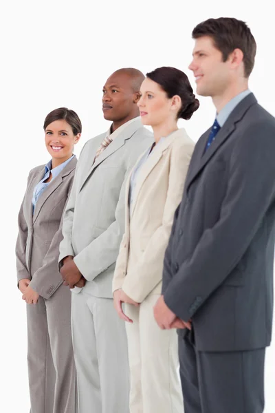 Smiling saleswoman standing next to her colleagues — Stock Photo, Image