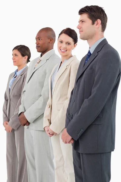Smiling saleswoman standing between her colleagues — Stock Photo, Image