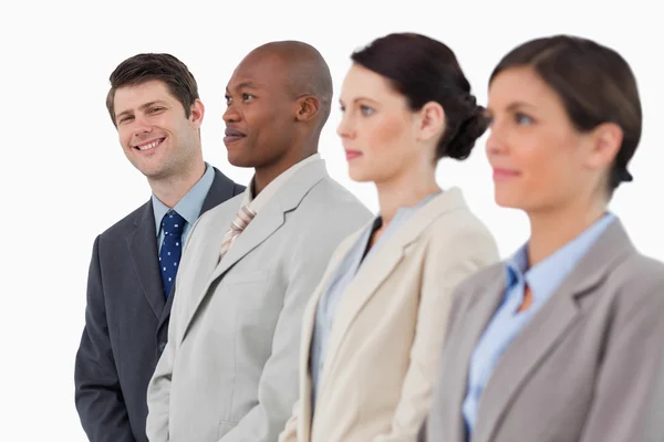 Smiling businessman standing next to his colleagues — Stock Photo, Image
