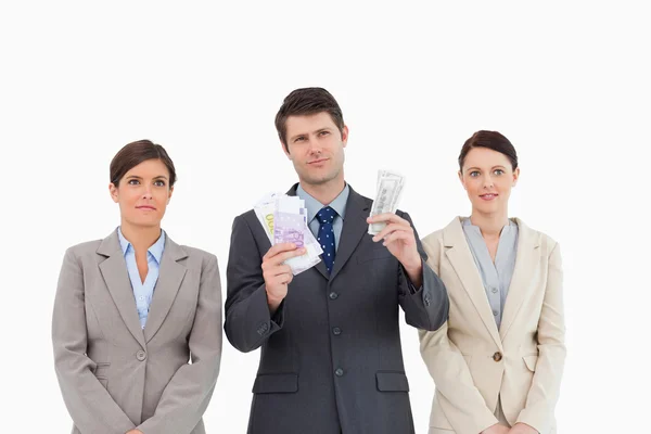 Businessman with money standing between employees — Stock Photo, Image