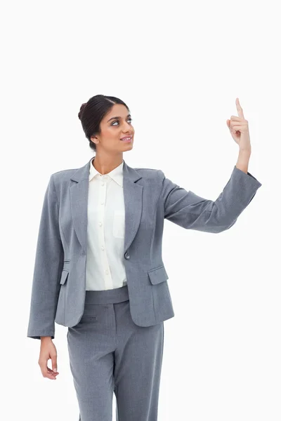 Smiling saleswoman pointing up — Stock Photo, Image