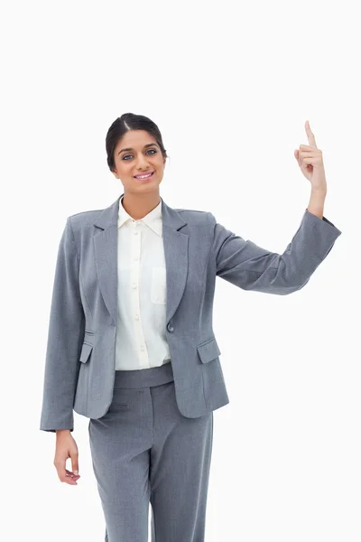 Smiling saleswoman pointing upwards — Stock Photo, Image