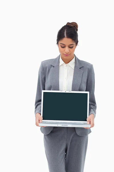 Businesswoman looking at laptop in her hands — Stock Photo, Image