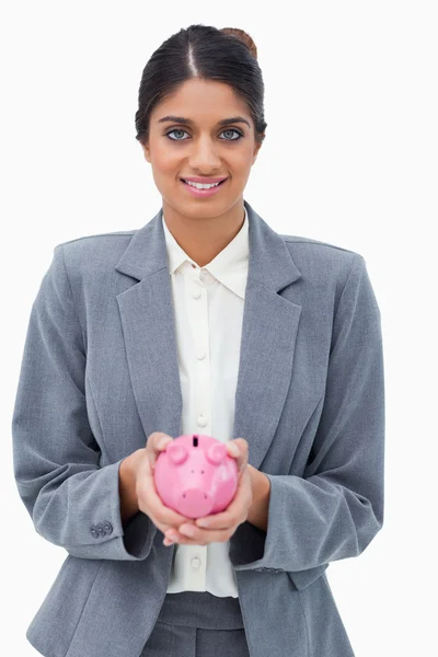 Smiling bank employee holding piggy bank — Stock Photo, Image