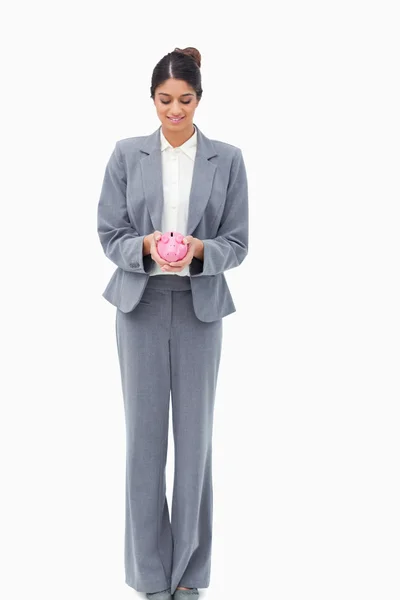 Smiling bank assistant with piggy bank — Stock Photo, Image