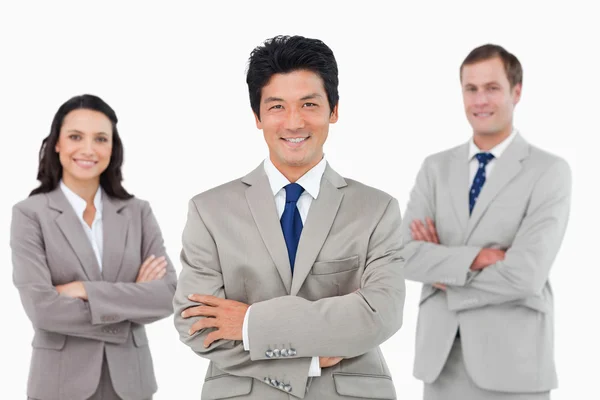 Smiling salesteam with arms folded — Stock Photo, Image