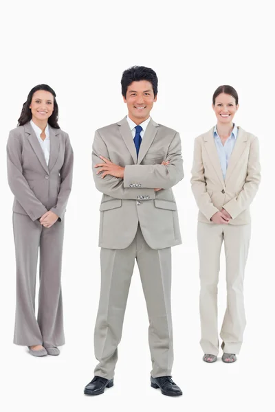 Smiling businessman with his staff behind him — Stock Photo, Image