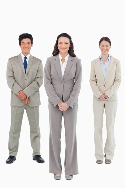 Smiling businesswoman with her team behind her — Stock Photo, Image