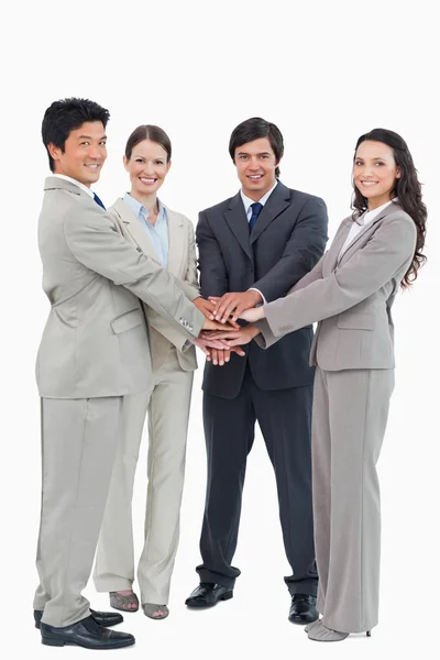 Smiling businessteam putting their hands together — Stock Photo, Image
