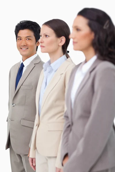 Smiling businessman next to colleagues — Stock Photo, Image
