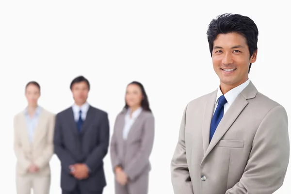 Businessman standing with his team behind him — Stock Photo, Image