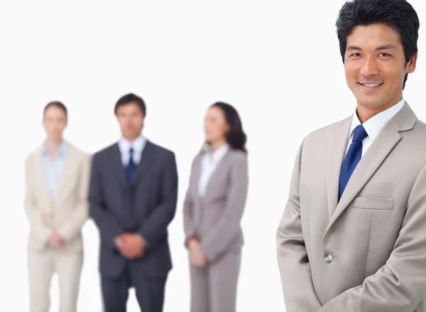 Businessman standing with his colleagues behind him — Stock Photo, Image