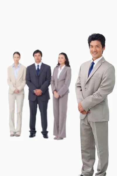 Podnikatel stojí se svými spolupracovníky za ním — Stock fotografie