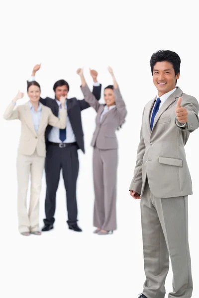 Salesman giving thumb up while getting celebrated — Stock Photo, Image