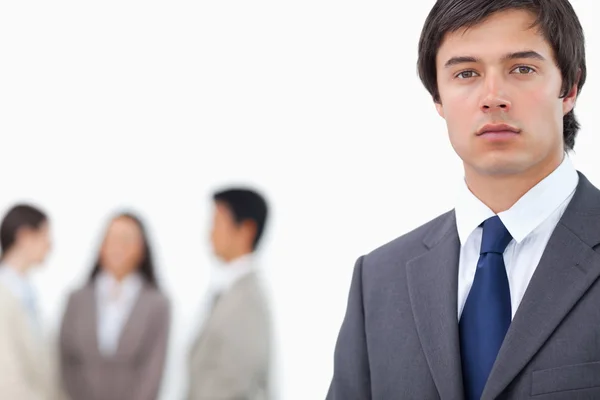 Young businessman with team behind him — Stock Photo, Image