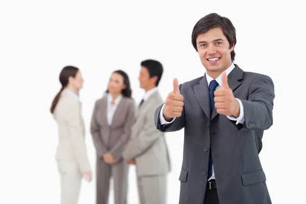 Salesman giving his approval with team behind him — Stock Photo, Image