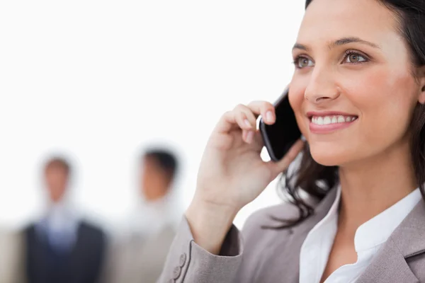 Smiling saleswoman on her phone — Stock Photo, Image