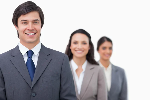 Smiling salesteam standing in line — Stock Photo, Image