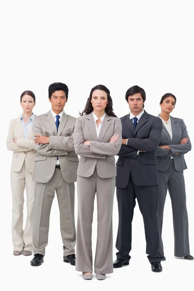 Serious businessteam standing with arms folded — Stock Photo, Image