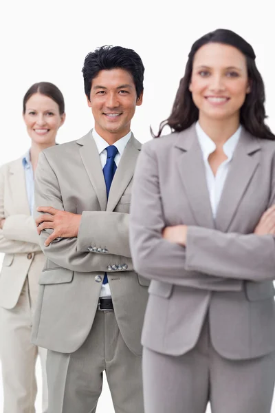 Smiling businessteam standing with folded arms — Stock Photo, Image