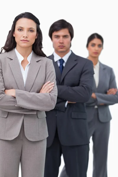 Serious salesteam standing together with folded arms — Stock Photo, Image