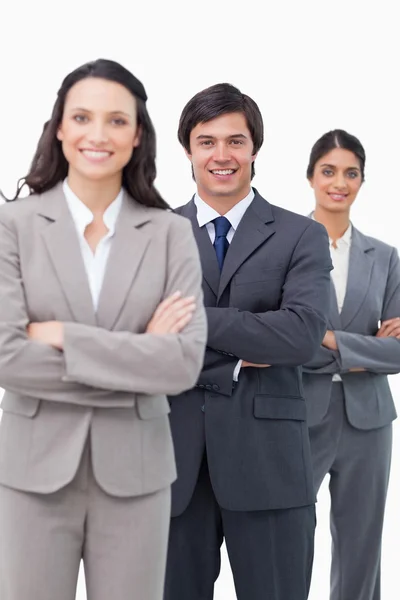 Smiling young salesteam standing together with arms folded — Stock Photo, Image