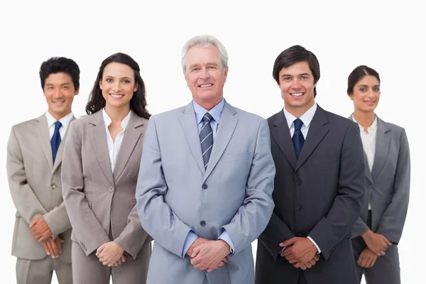 Smiling mature businessman standing with his team — Stock Photo, Image