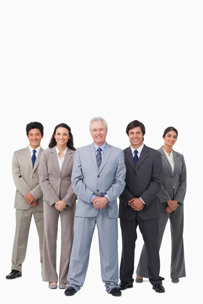 Smiling mature salesman standing together with his team — Stock Photo, Image