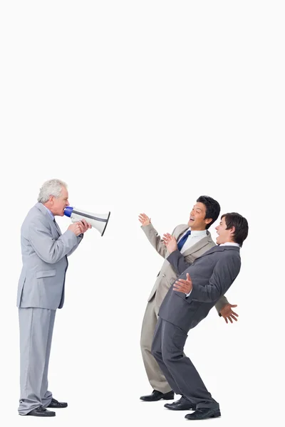 Homem de negócios maduro com megafone gritando com seus funcionários — Fotografia de Stock