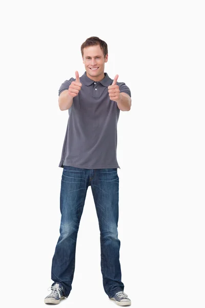Lachende jonge man geven duimen omhoog — Stockfoto