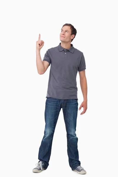 Young man pointing and looking up — Stock Photo, Image
