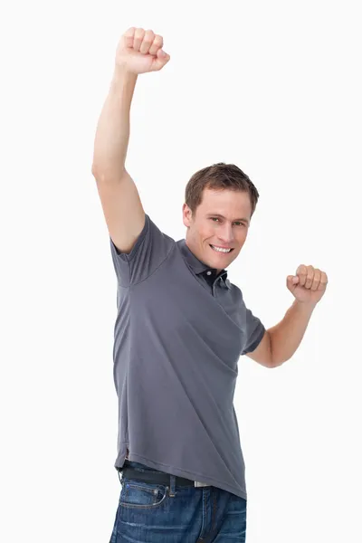 Joven victorioso levantando puño — Foto de Stock
