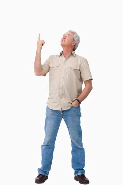 Mature male looking and pointing up — Stock Photo, Image