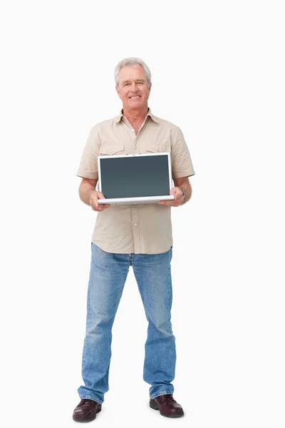 Glimlachend volwassen mannetje presenteren van zijn laptop scherm — Stockfoto