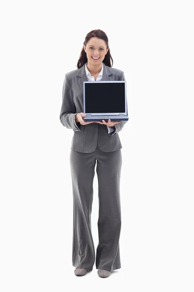Zakenvrouw glimlachen terwijl een laptop scherm wordt weergegeven — Stockfoto