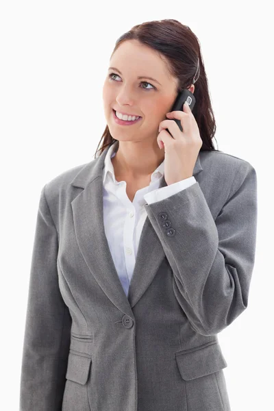 Businesswoman looking up while smiling on the phone — Stock Photo, Image