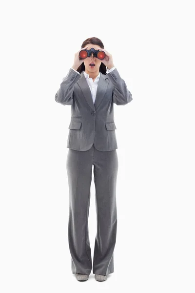 Verrast zakenvrouw op zoek door middel van verrekijkers — Stockfoto